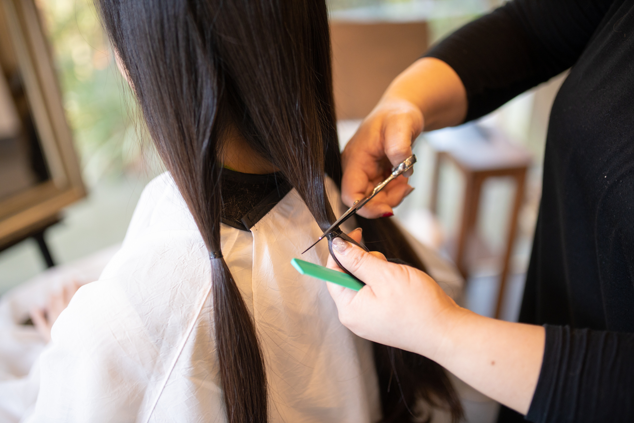woman-cutting-hair-for-charitable-donationjpg
