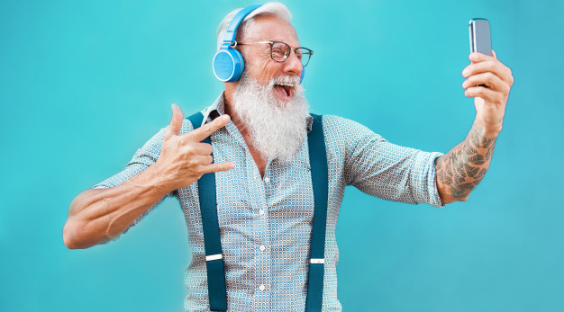 senior-crazy-man-using-smartphone-app-creating-playlist-with-rock-music-trendy-tattoo-guy-having-fun-with-mobile-phone-technology-tech-joyful-elderly-lifestyle-concept-focus-face_166273-216jpg